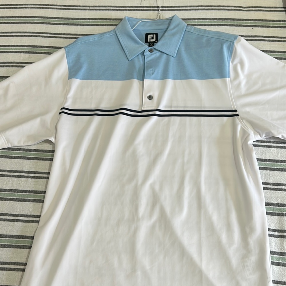 white and blue footjoy golf shirt.